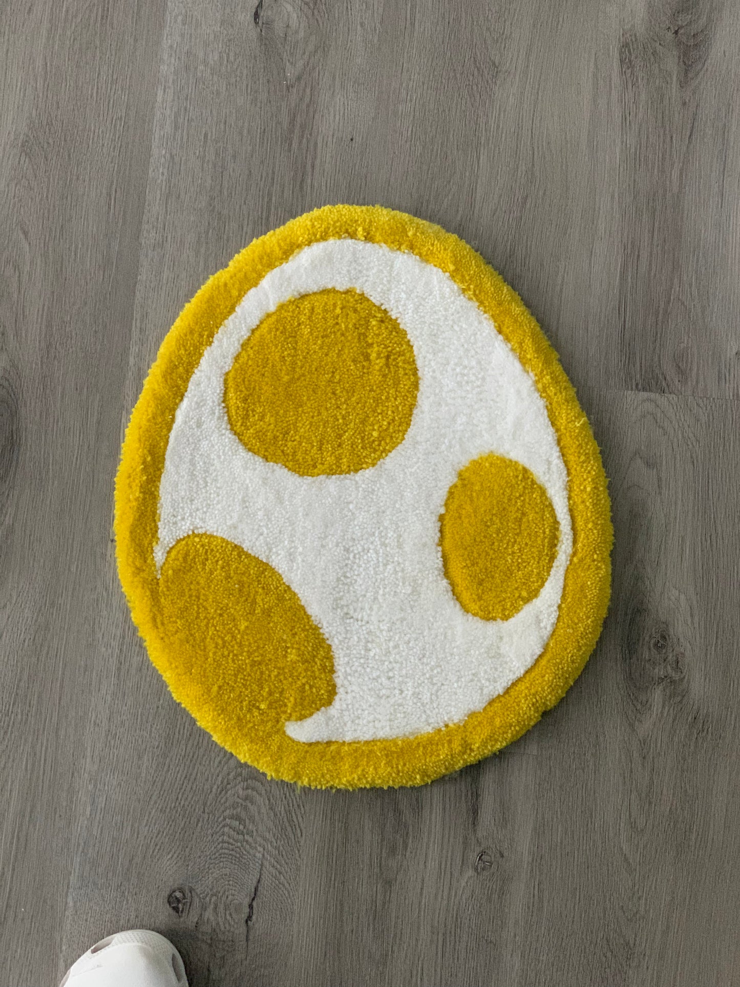 Custom-made tufted rug featuring a Mario, Yoshi Egg design. Handcrafted with love, this unique piece adds an awesome touch to any space.