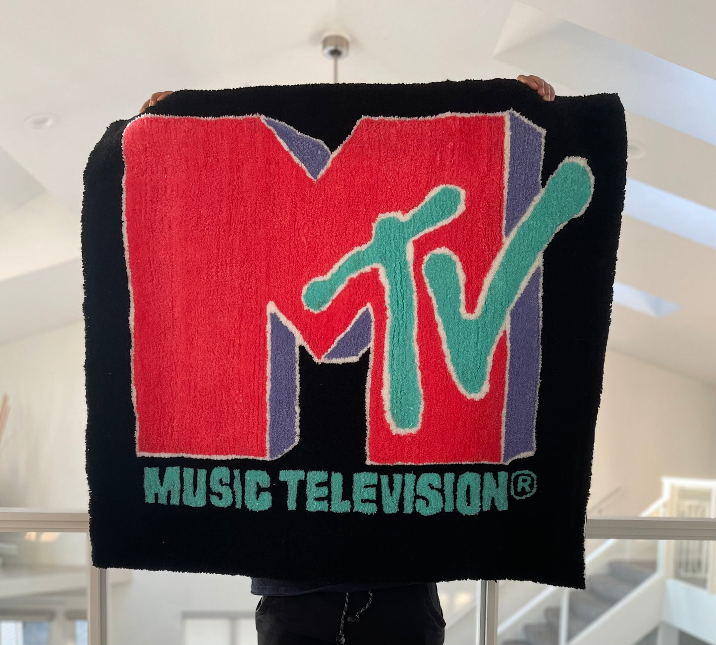 Custom-made tufted rug featuring a MTV design. Handcrafted with love, this unique piece adds an awesome touch to any space.